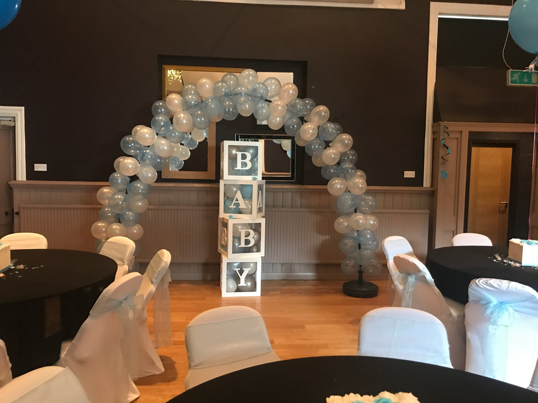 Organic balloon arch and baby boxes for a baby shower
