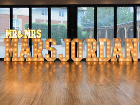 Mr & Mrs Mars-Jordan in light up letters for their special wedding day. 