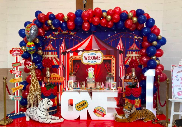 Childrens circus themed party, circus backdrop, organic balloon arch, circus props, circus animals and a light up number