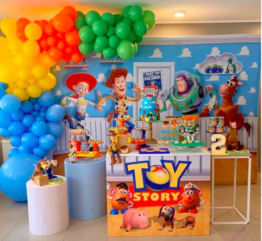 Toy Story themed party, toy story backdrop with orange balloon arch