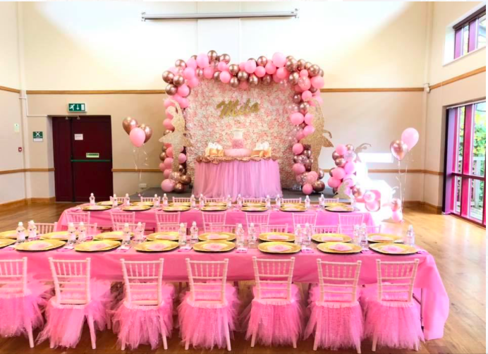 Ballerina themed princess party. pink flower wall with childrens table decoration set up. 