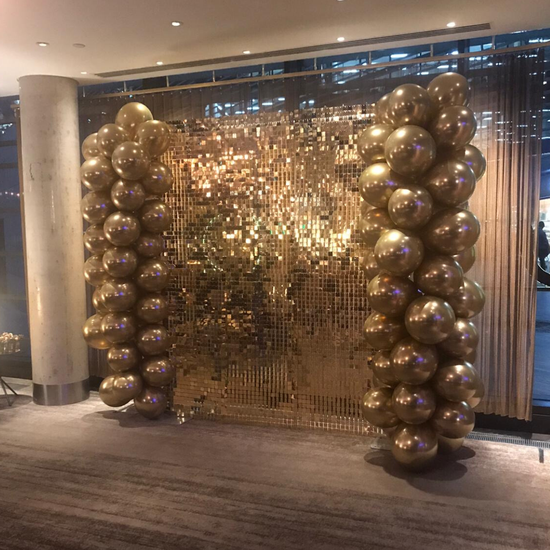 Michael Kors christmas party with our gold sequin wall and organic balloon columns